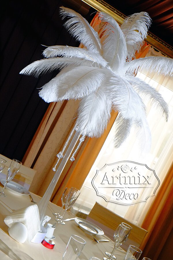 На столах возвышаются композиции из страусиных перьев, высокие вазы декорированы сверкающими стразами