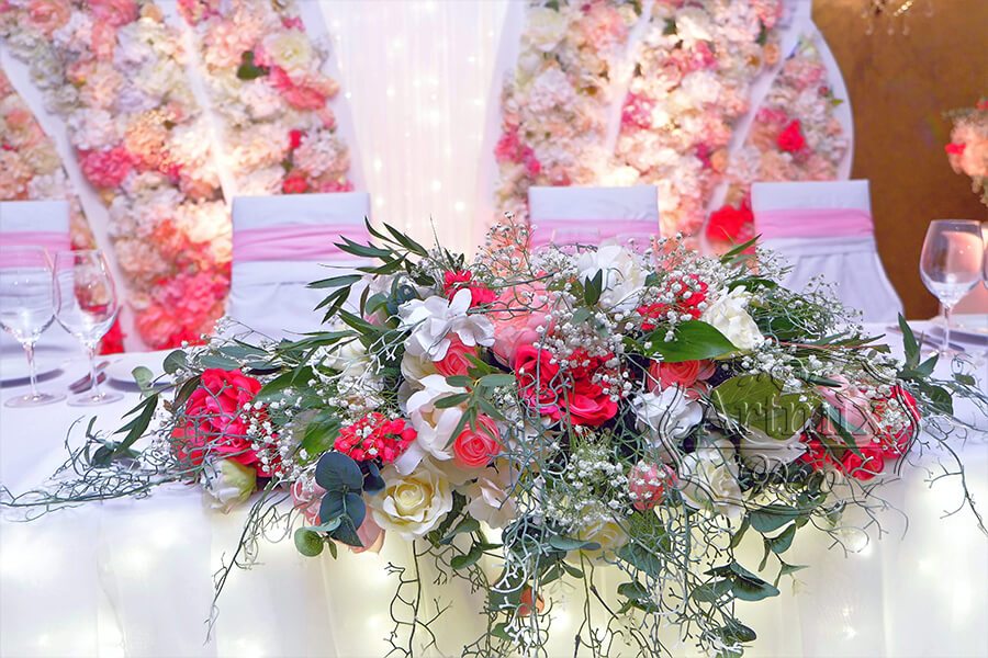 Центральная цветочная композиция в оформлении стола жениха и невесты